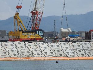 辺野古沿岸の「K4」護岸では、石材の上に被覆ブロックを設置する作業が続いた=26日午前10時42分、名護市辺野古の米軍キャンプ・シュワブ沿岸