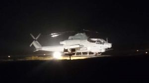 渡名喜村の村営ヘリポートに着陸した米軍のAH1攻撃ヘリコプター=23日午後10時ごろ(住民提供)