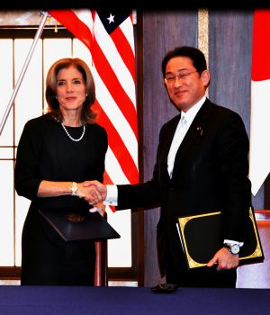 日米地位協定の米軍属についての補足協定にサインし握手する岸田外相(右)とケネディ米駐日大使=16日、都内の外務省・飯倉公館
