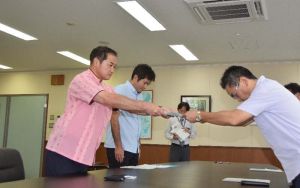 沖縄防衛局の中嶋浩一郎局長(右)に抗議要請文を手渡す佐喜真淳宜野湾市長=11日午前10時ごろ、沖縄防衛局