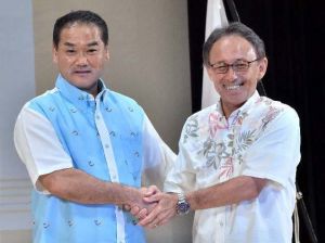 討論会を終え握手を交わす佐喜真淳氏(左)と玉城デニー氏=5日、南風原町立中央公民館