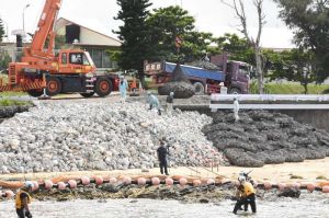 K1護岸建設予定地で進む仮設道路の作業=1日午前、名護市辺野古のキャンプ・シュワブ内の砂浜