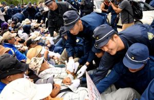 座り込む市民を強制排除する機動隊員=9月、東村高江
