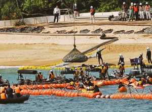 辺野古新基地建設に向けた護岸工事で、ネットに入った石材が海に投入される=25日午前9時26分、名護市の米軍キャンプ・シュワブ(下地広也撮影)